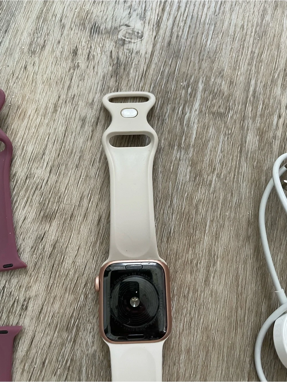 Apple Smartwatch with White, Black, and Mauve Bands